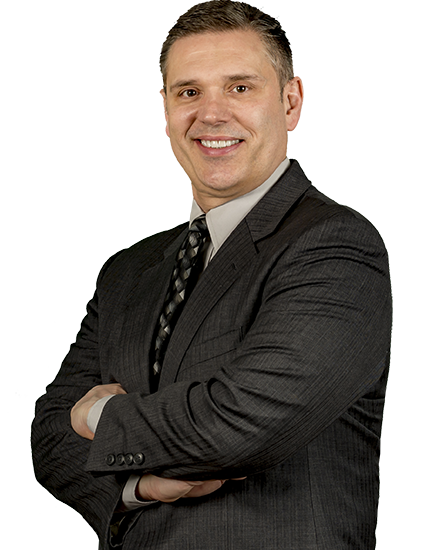 Daniel Gigiano with arms crossed in suit wearing a smile