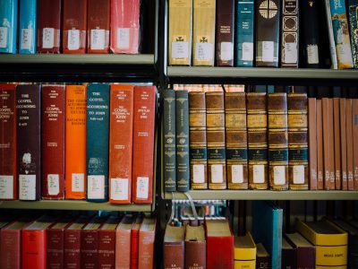 library shelves full of old leather-bound books